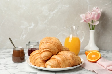 Photo of Tasty croissants served for breakfast on table