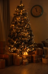 Stylish Christmas interior of living room with beautiful tree in evening