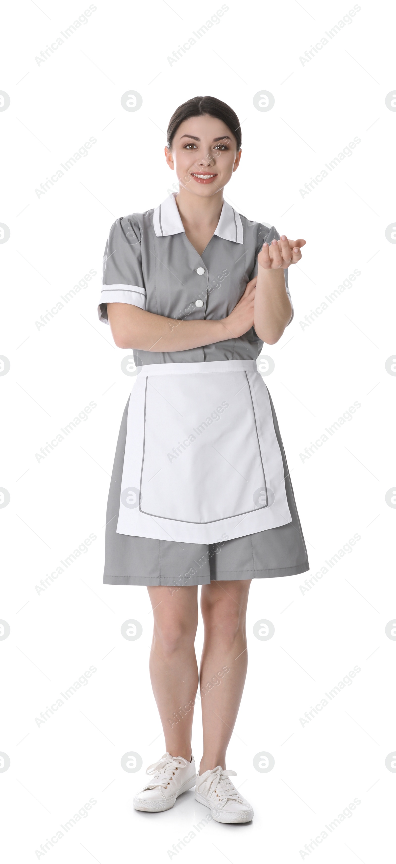 Photo of Young chambermaid in uniform on white background