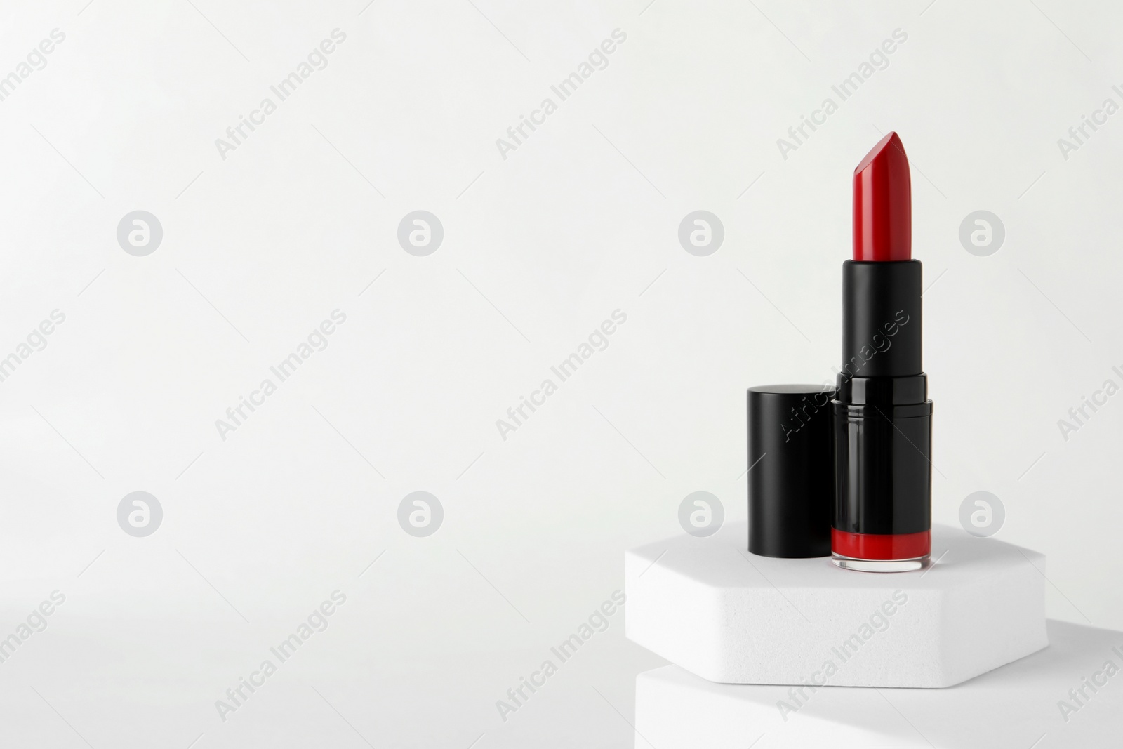 Photo of Beautiful glossy red lipstick on white background, space for text