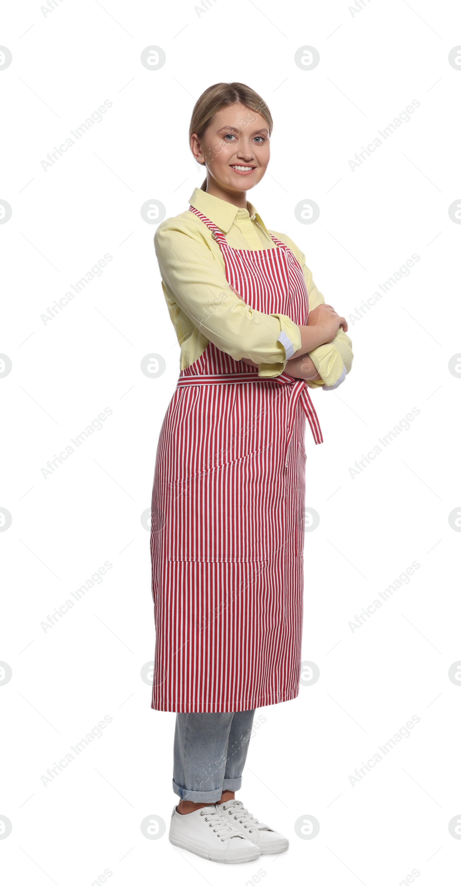 Photo of Beautiful young woman in clean striped apron on white background