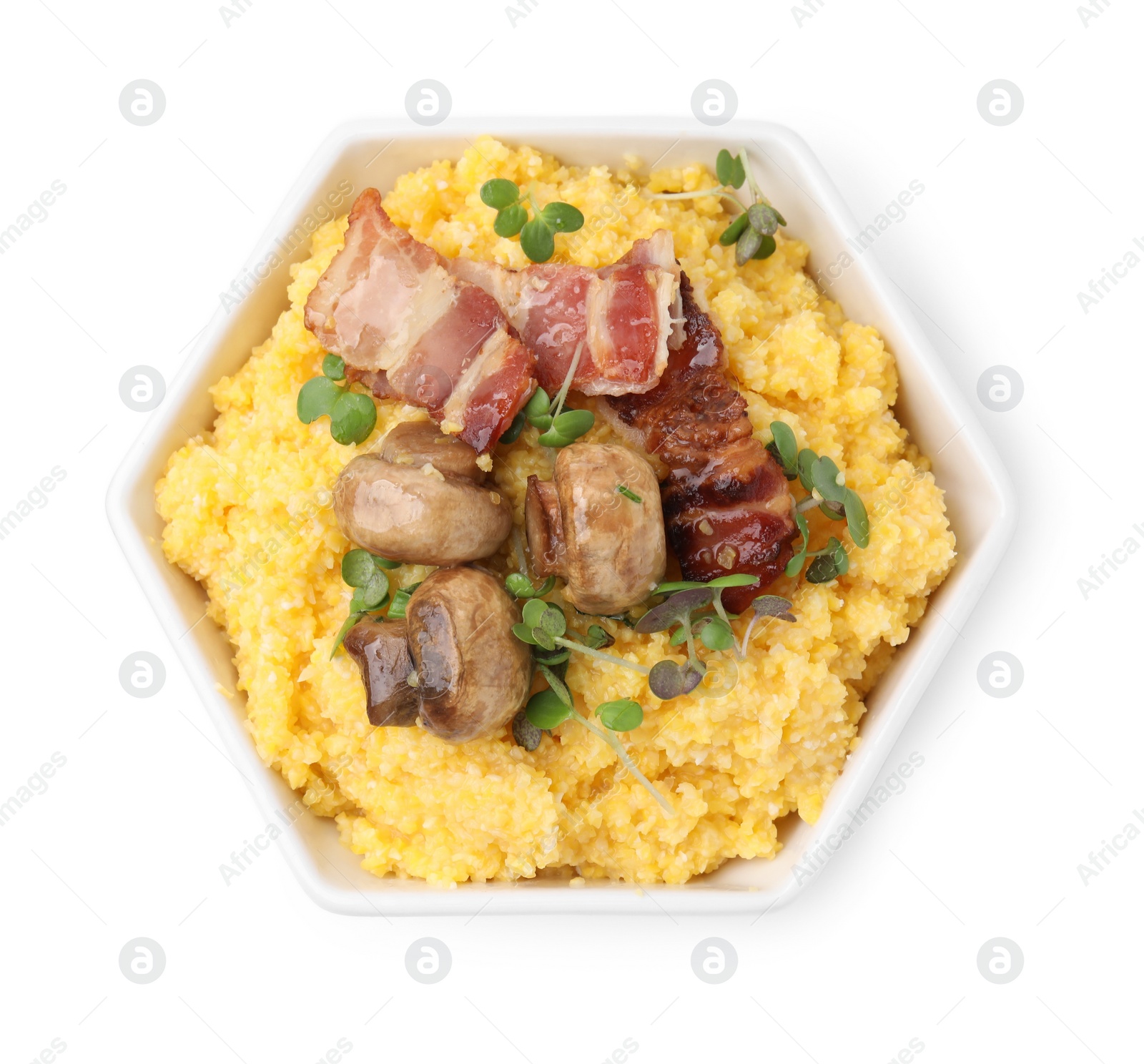 Photo of Cooked cornmeal with bacon, mushrooms and microgreens in bowl isolated on white, top view