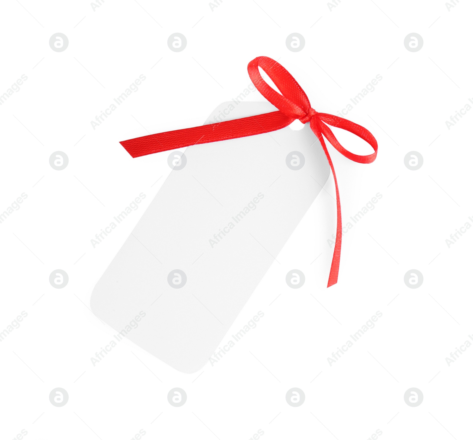 Photo of Blank gift tag with red satin ribbon on white background, top view