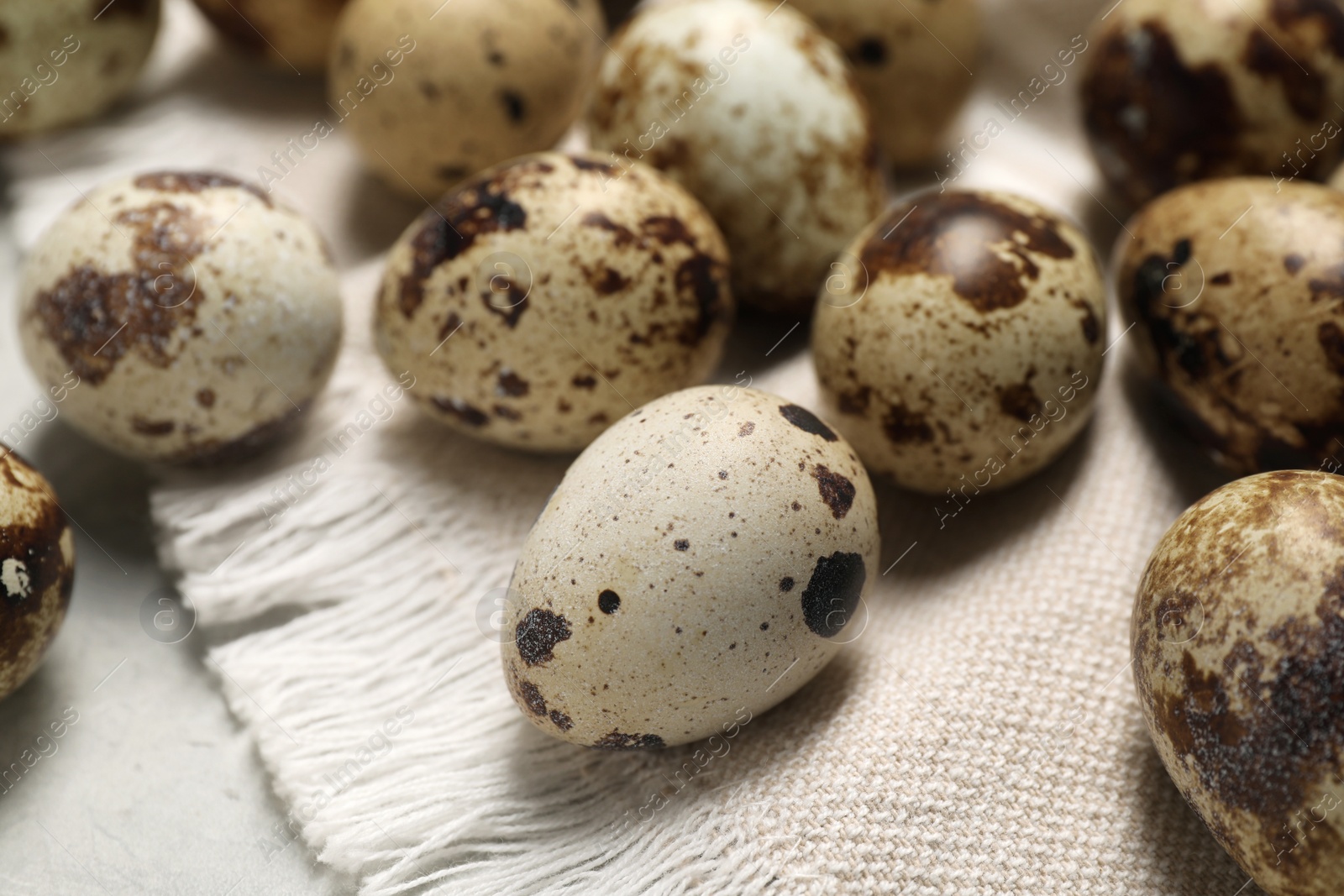 Photo of Many speckled quail eggs on table, closeup