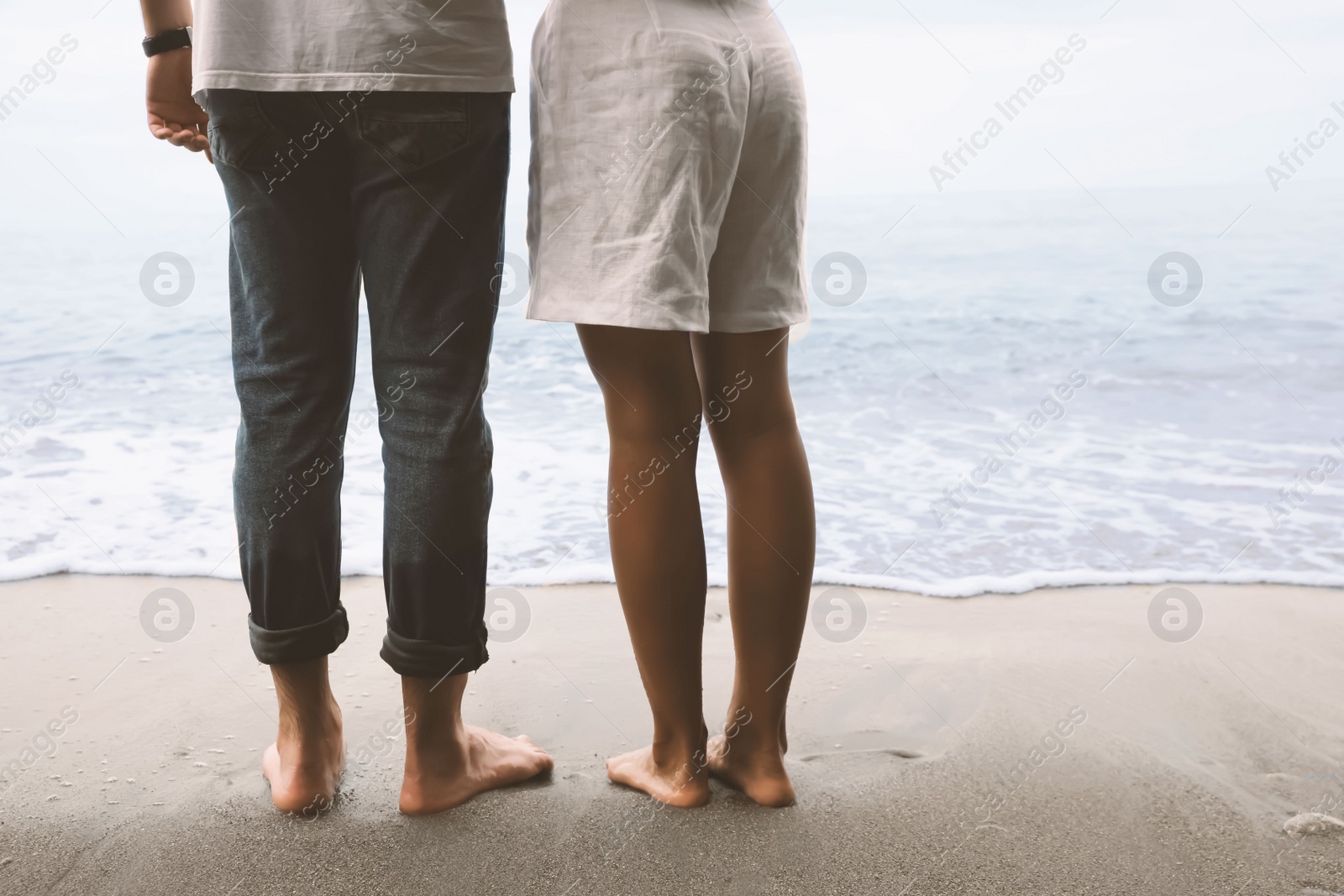 Photo of Young couple on beach near sea, closeup