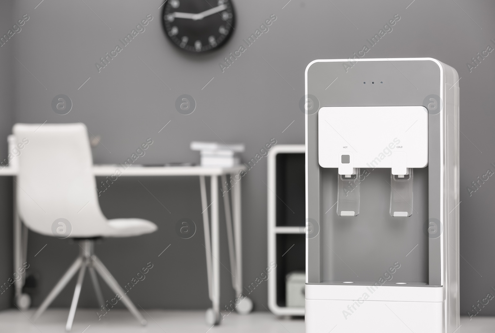 Photo of Modern water cooler in stylish office interior