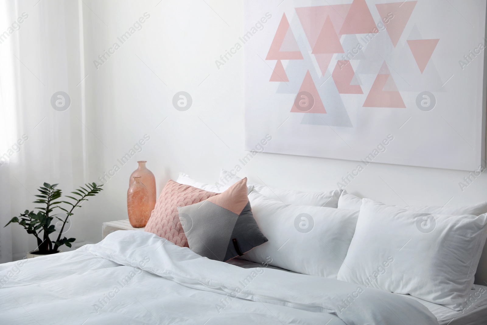 Photo of Comfortable bed with soft pillows in room interior