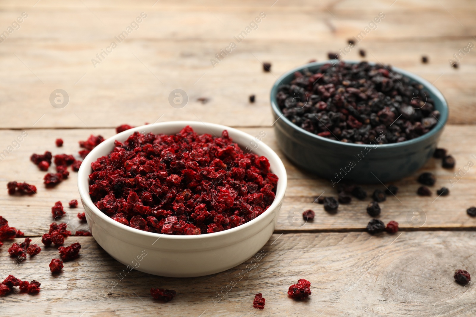 Photo of Dried red and black currant berries on wooden table