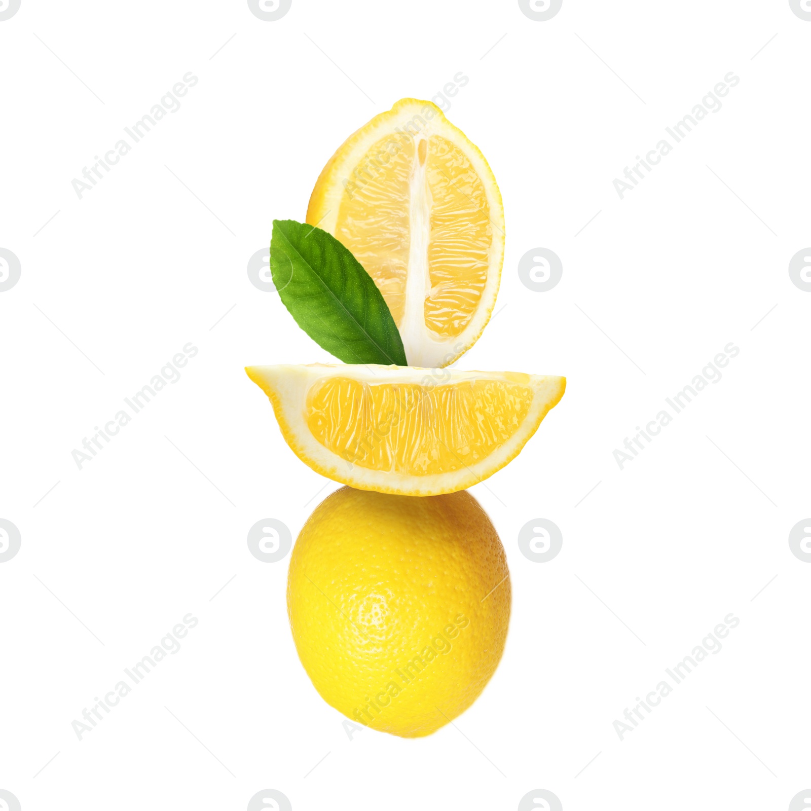 Image of Cut and whole fresh lemons with leaf isolated on white