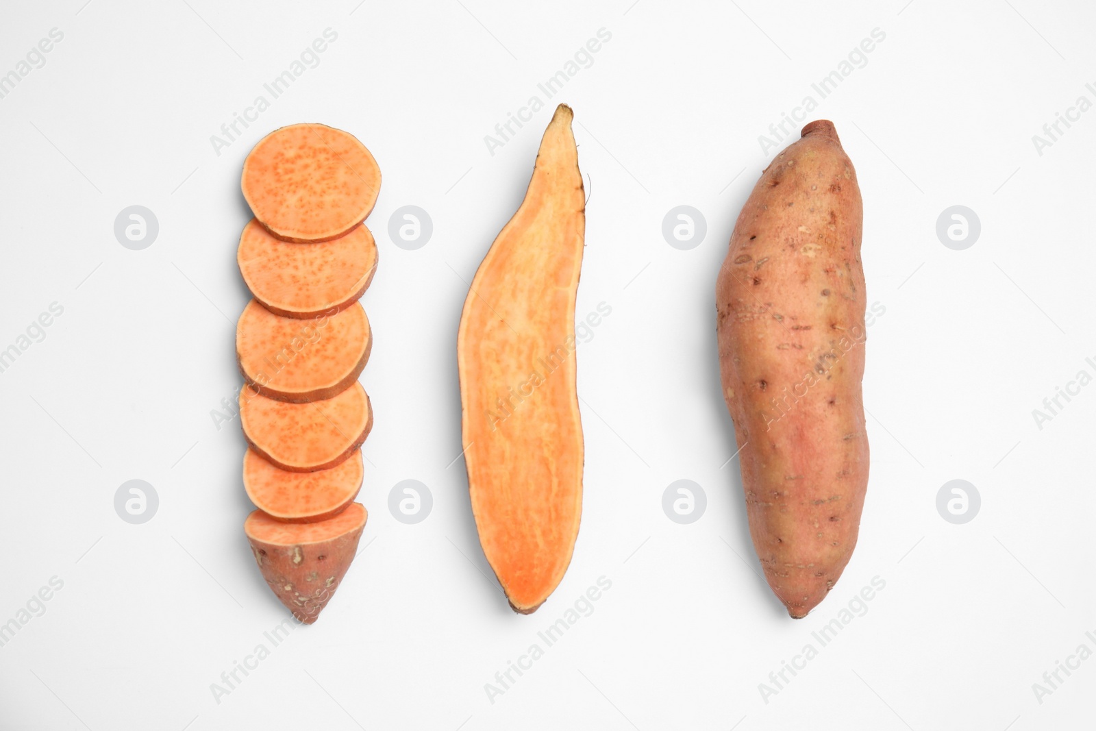 Photo of Cut and whole sweet potatoes on white background, top view