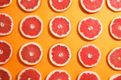 Photo of Fresh sliced ripe grapefruit on color background, flat lay