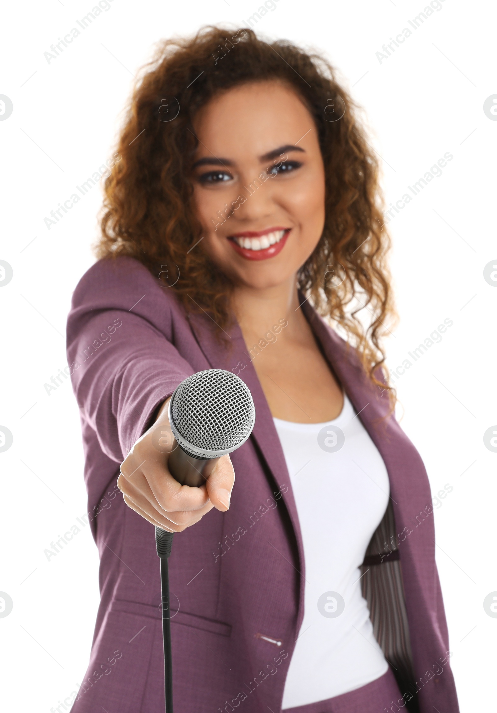 Photo of Curly African-American woman in suit with microphone on white background