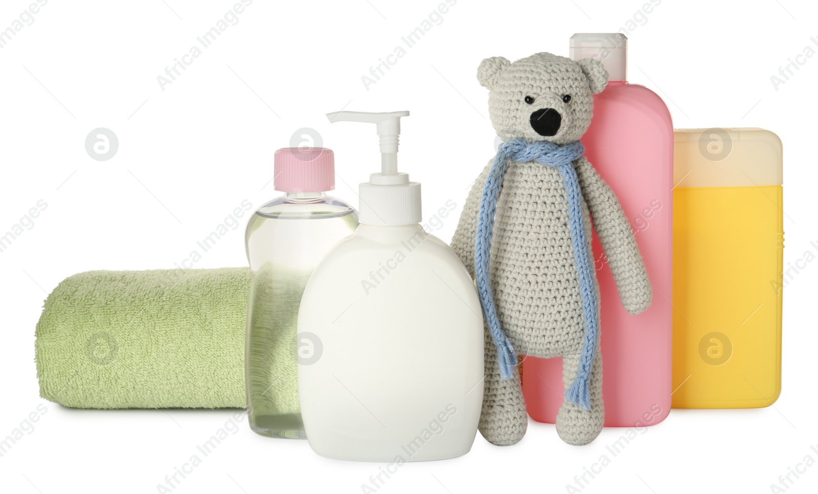 Photo of Bottles of baby cosmetic products, towel and toy bear on white background