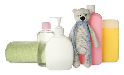 Bottles of baby cosmetic products, towel and toy bear on white background