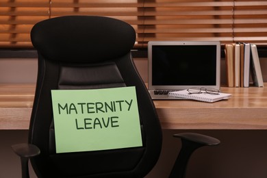 Photo of Note with text Maternity Leave on office chair back near workplace indoors