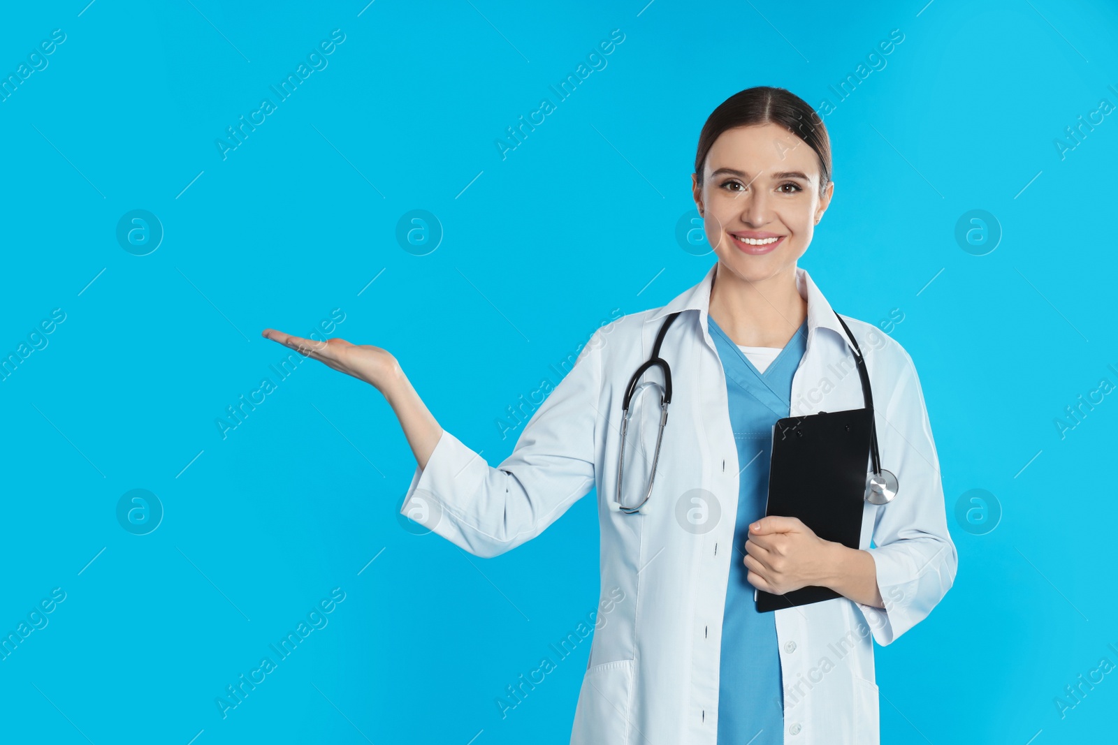 Photo of Doctor with stethoscope and clipboard on blue background