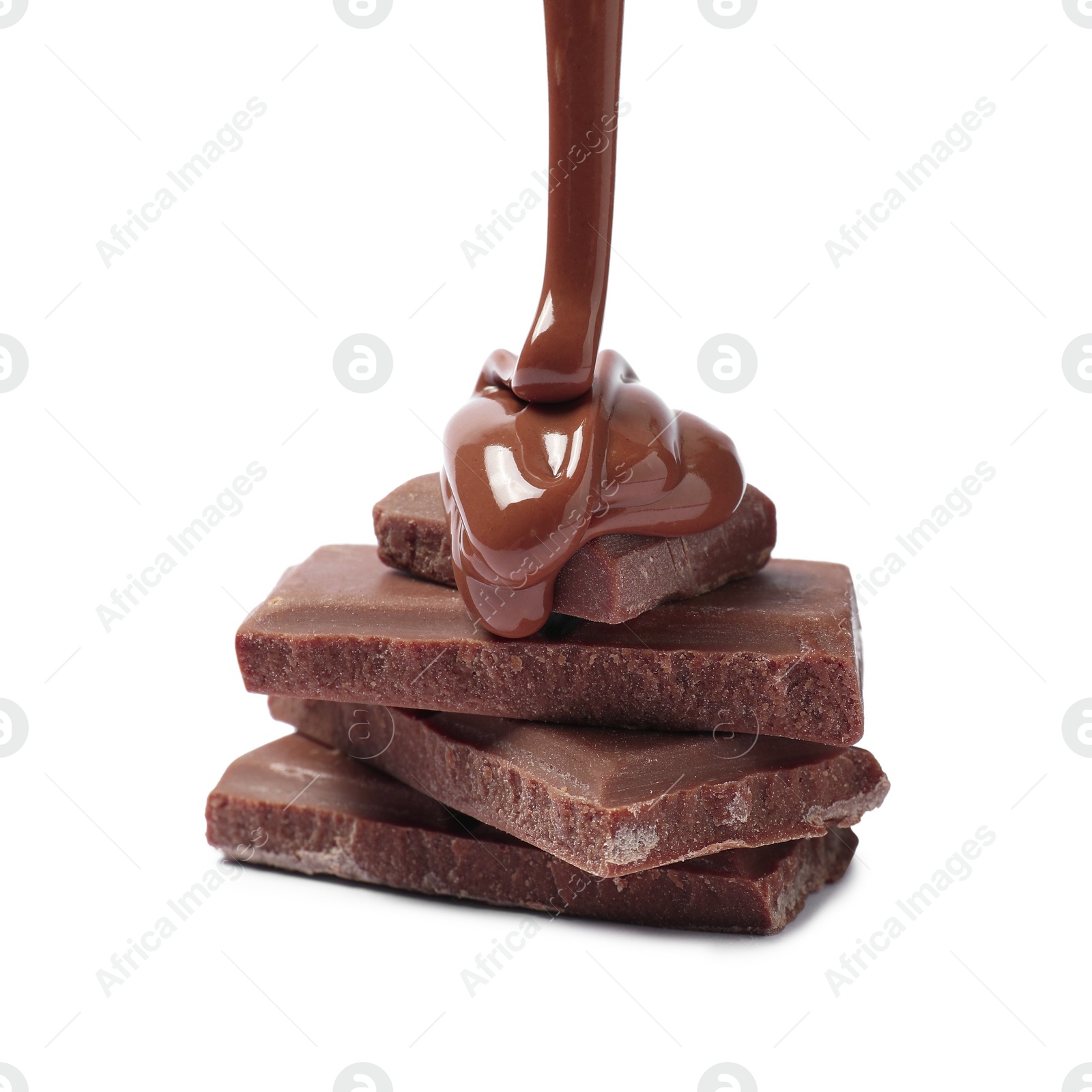 Photo of Pouring tasty milk chocolate paste onto pieces isolated on white