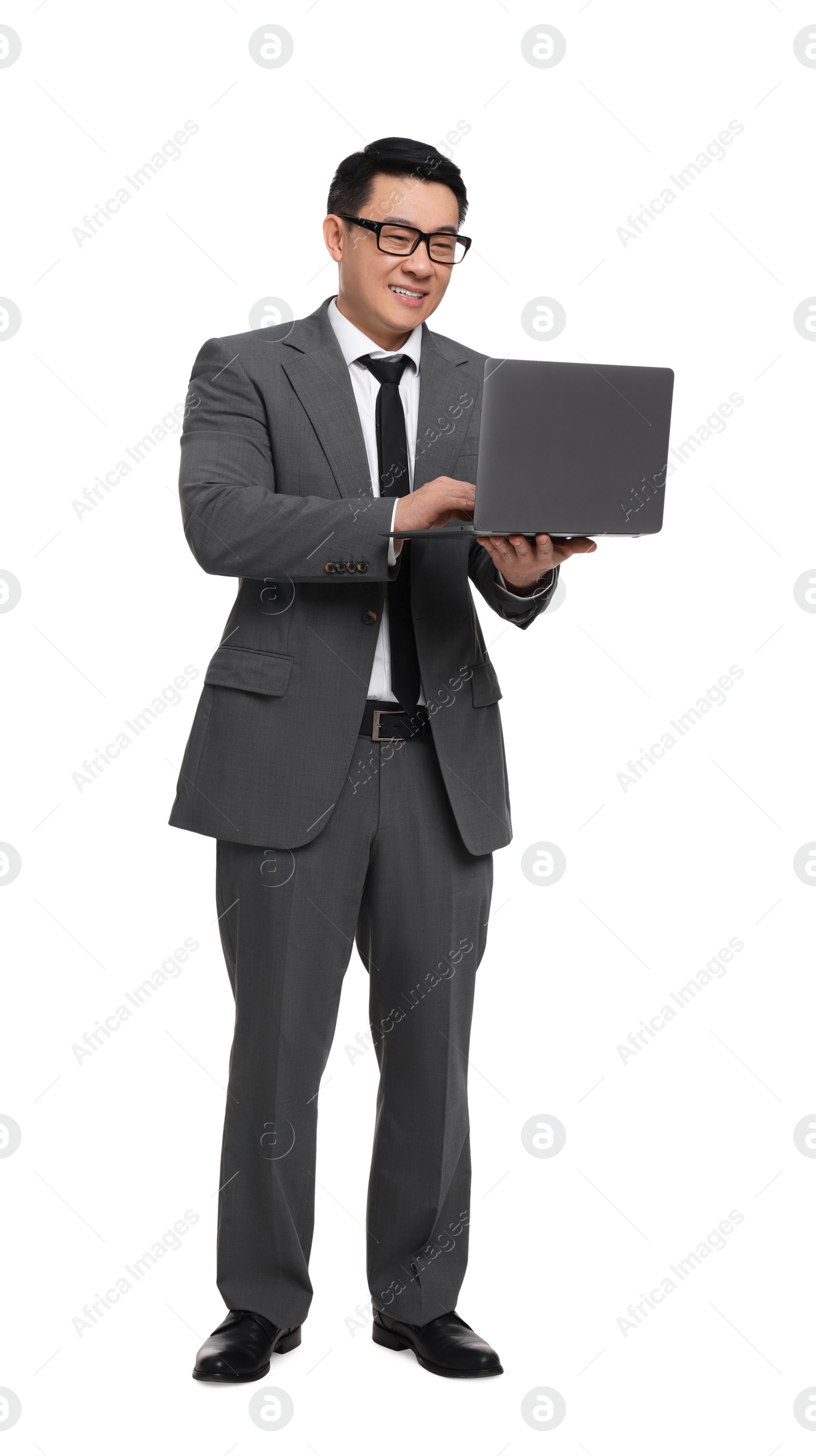 Photo of Businessman in suit working on laptop against white background