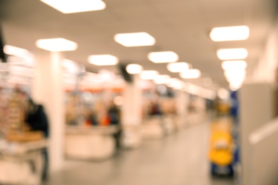 Photo of Blurred view of modern shopping mall interior