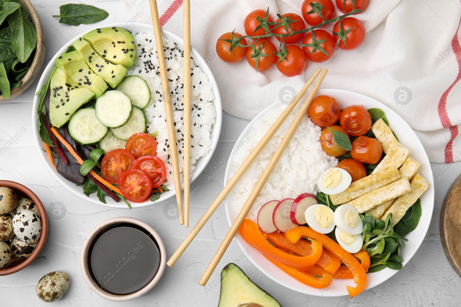 Photo of Delicious poke bowls and ingredients on white table, flat lay