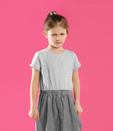 Photo of Portrait of upset little girl on pink background
