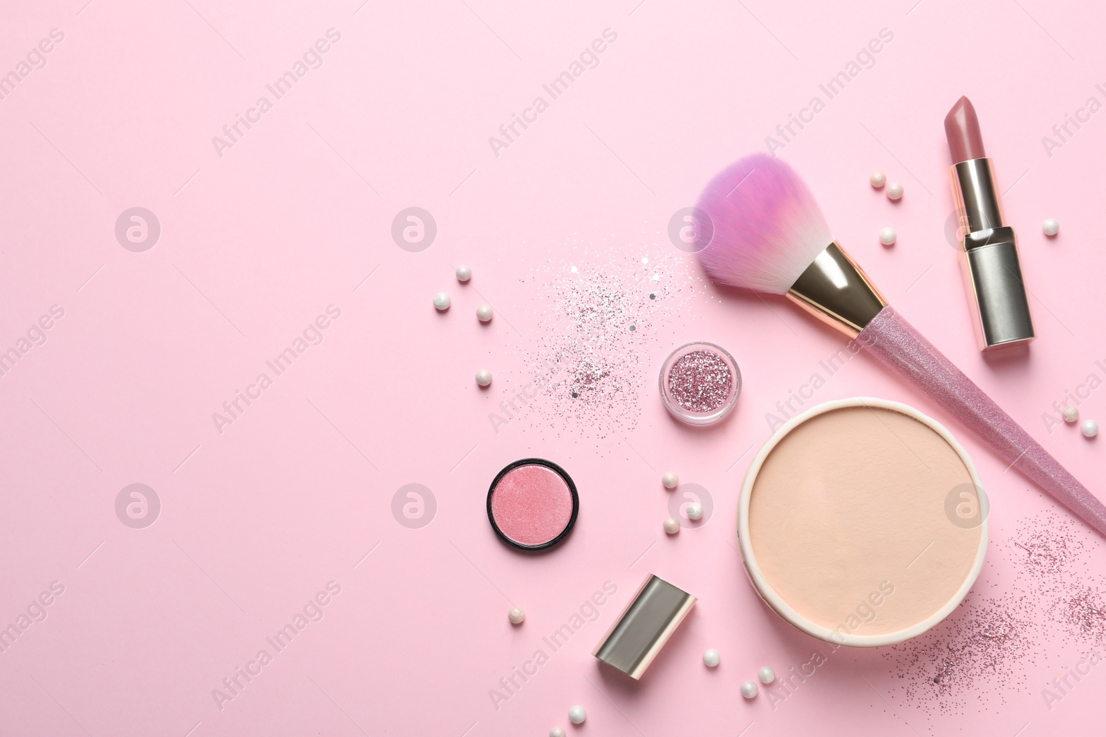 Photo of Flat lay composition with makeup brushes on pink background. Space for text