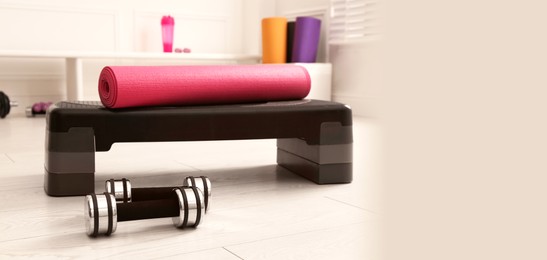 Image of Step platform, mat and dumbbells indoors, space for text. Banner design