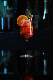 Photo of Delicious sangria cocktail on black table in bar