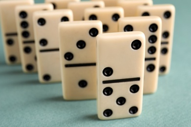 Photo of Classic domino tiles on grey background, closeup