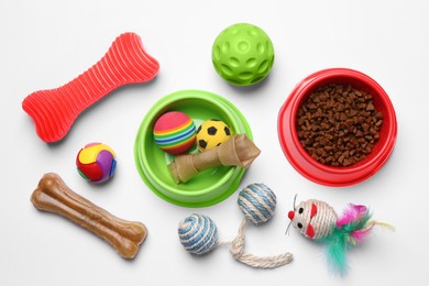 Photo of Flat lay composition with pet toys and food on white background