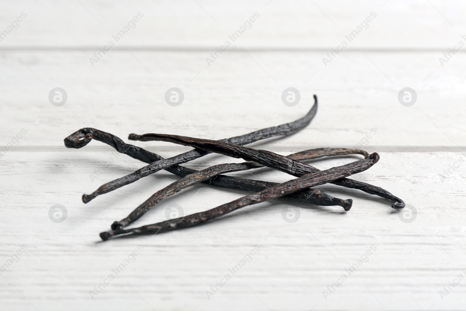 Photo of Bunch of vanilla sticks on wooden background