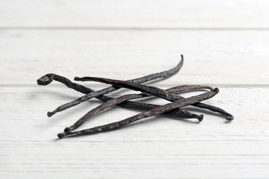 Bunch of vanilla sticks on wooden background