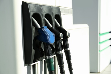 Photo of Petrol pump filling nozzles at gas station