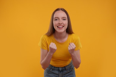 Photo of Emotional sports fan celebrating on yellow background