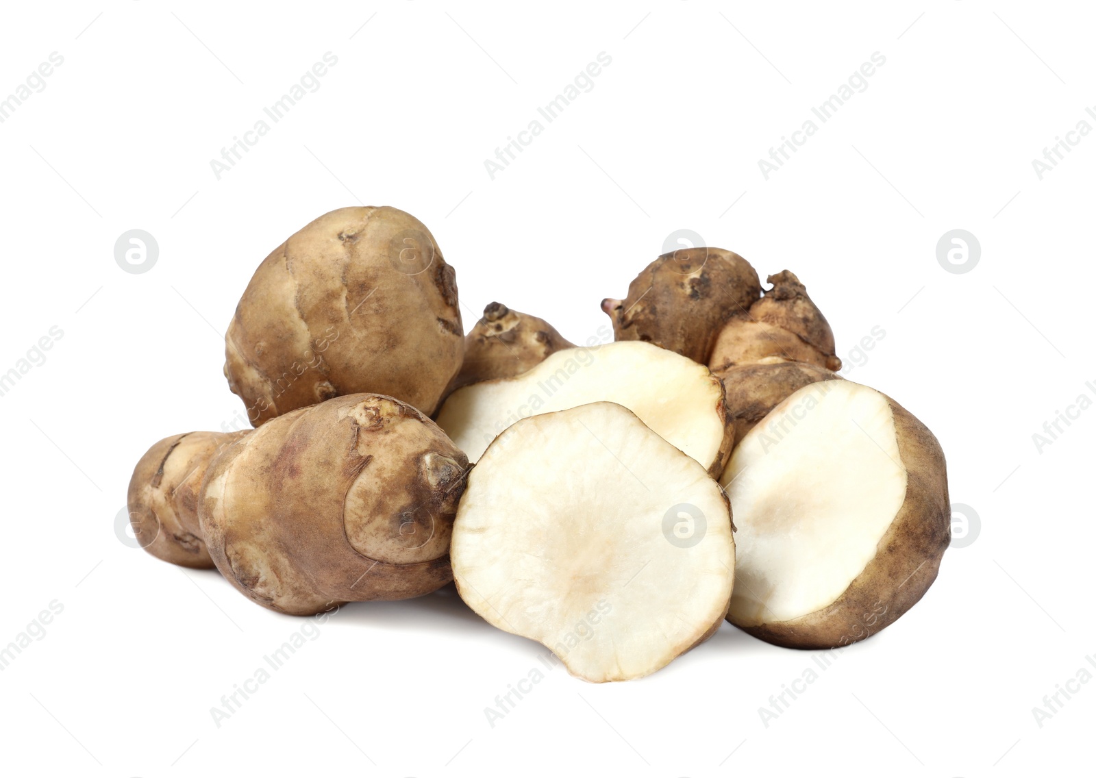 Photo of Whole and cut Jerusalem artichokes isolated on white