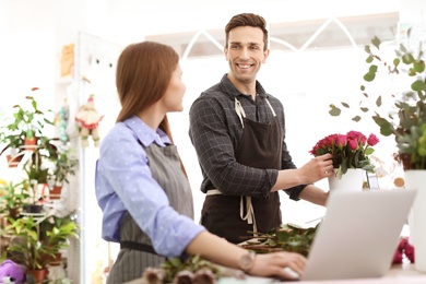 Photo of Male and female florists working in flower shop