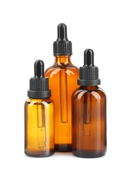 Photo of Glass bottles of tincture isolated on white