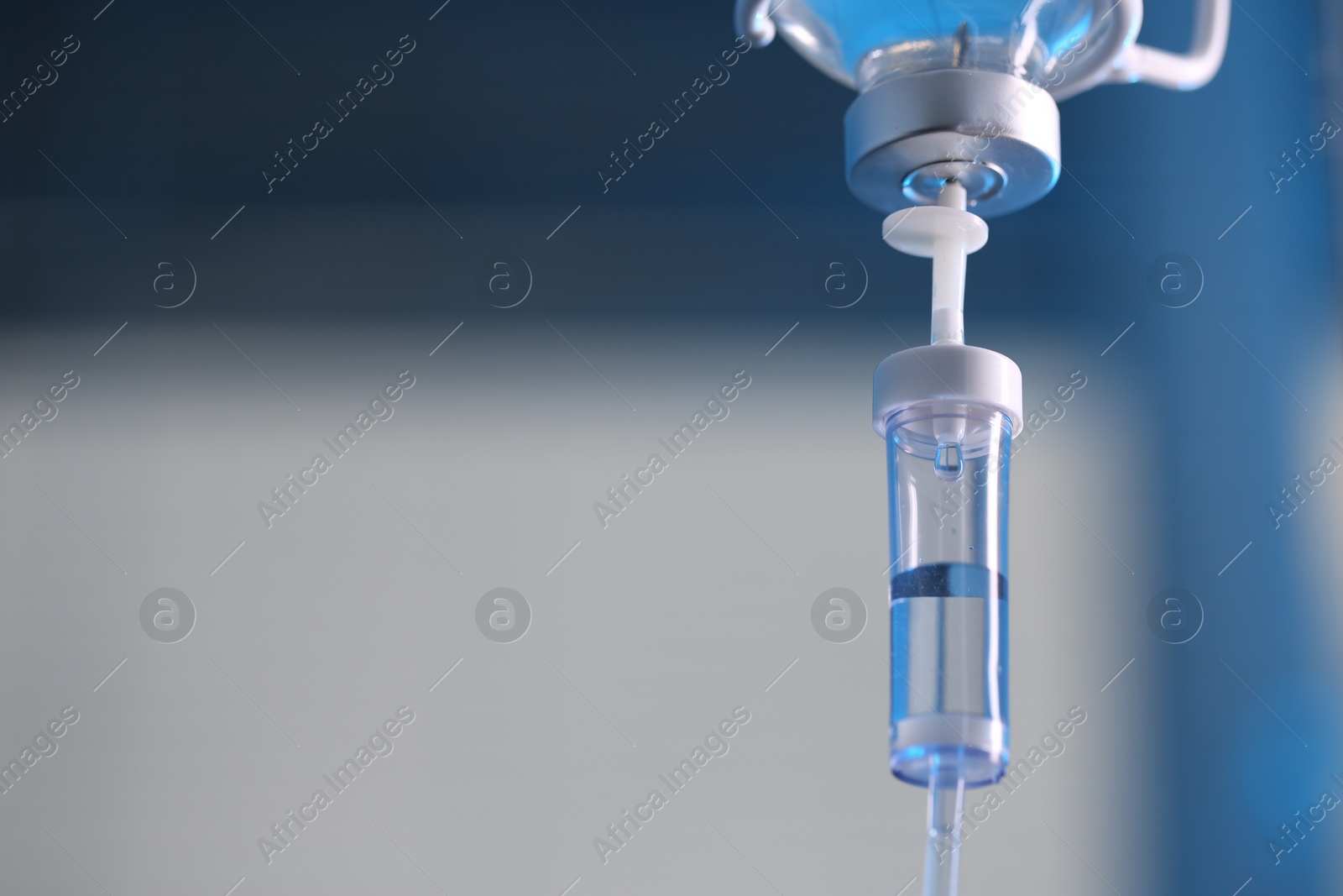 Photo of IV drip against blurred background, space for text