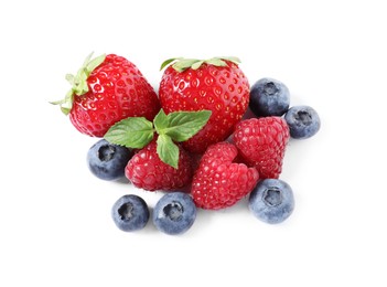 Photo of Many different ripe berries and mint leaves isolated on white