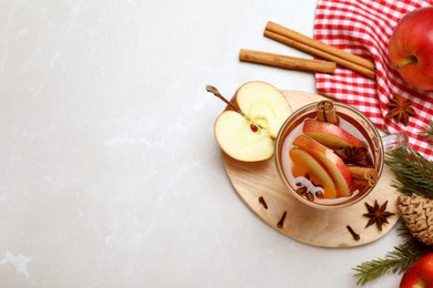 Aromatic hot mulled cider on light grey marble table, flat lay. Space for text