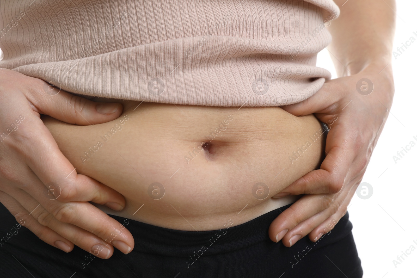 Photo of Woman touching belly fat on white background, closeup. Overweight problem