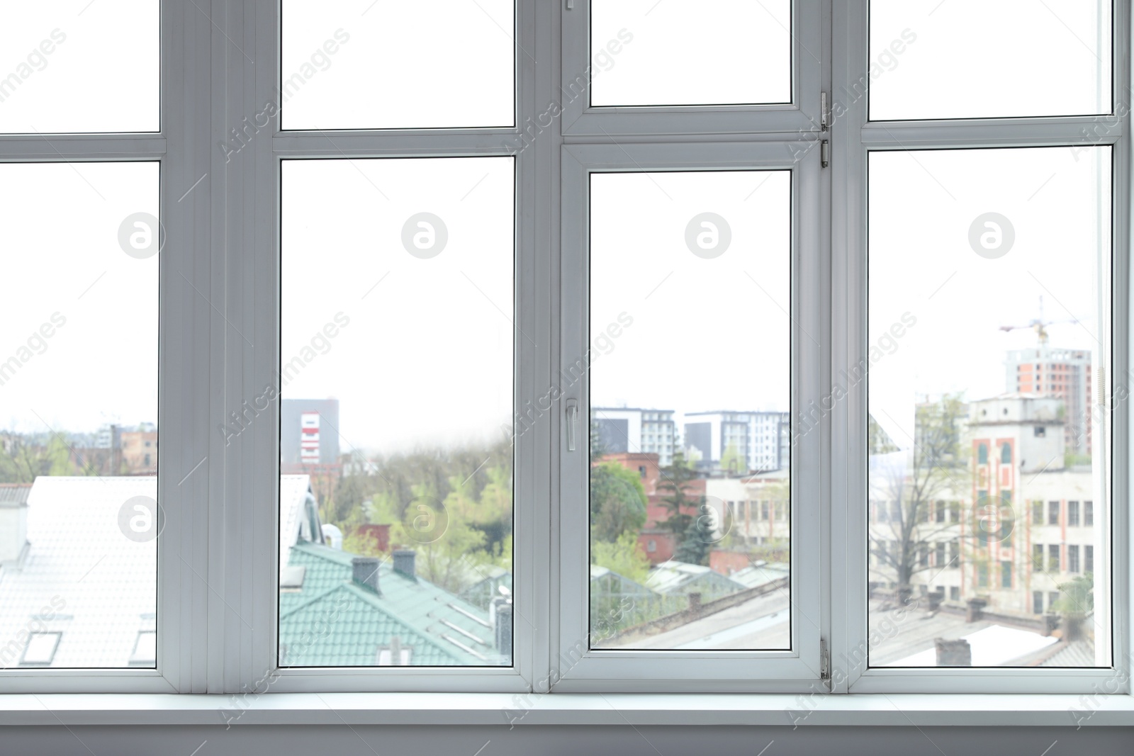 Photo of Stylish window with white frame in office