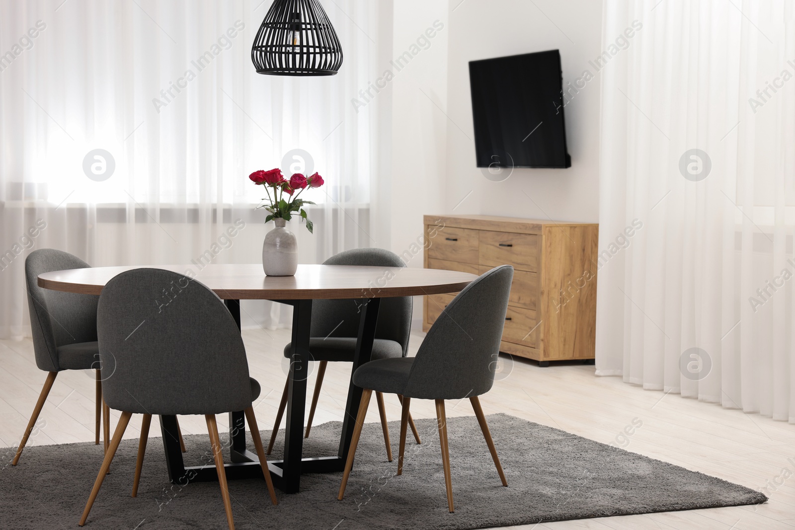 Photo of Stylish dining room interior with table and chairs