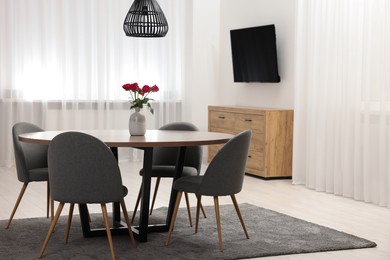 Photo of Stylish dining room interior with table and chairs