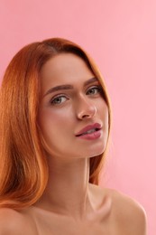 Portrait of beautiful young woman on pink background, closeup