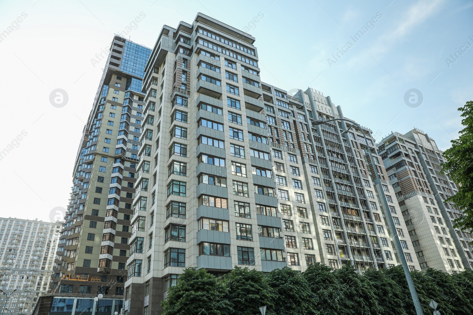 Photo of KYIV, UKRAINE - MAY 21, 2019: Beautiful view of modern housing estate in Pecherskyi district on sunny day, low angle