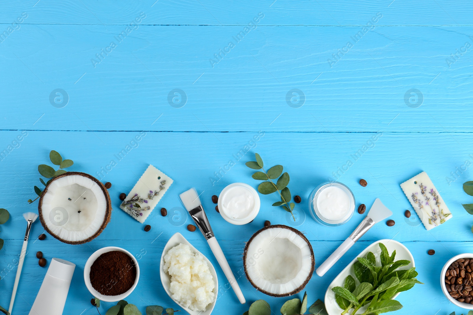 Photo of Flat lay composition with homemade cosmetic products and fresh ingredients on light blue wooden table. Space for text