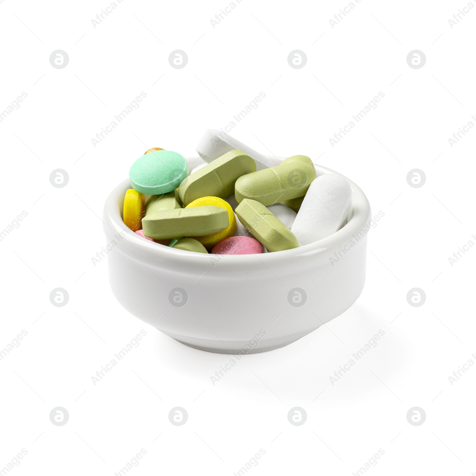 Photo of Different vitamin capsules in bowl isolated on white