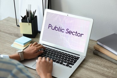 Image of Public Sector.  Woman working with modern laptop at wooden table, closeup 