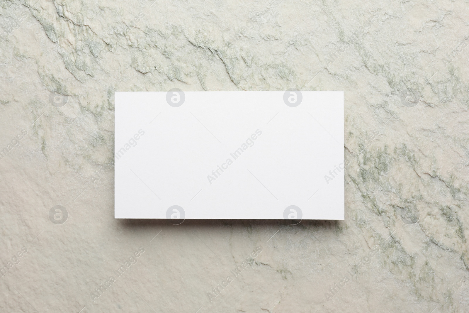 Photo of Empty business card light stone textured background, top view. Mockup for design